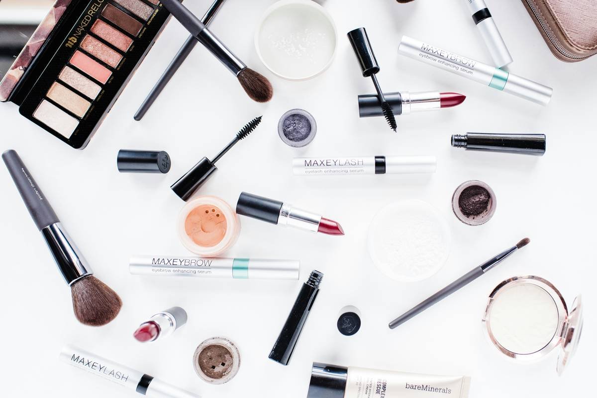 Side-by-side image: left shows messy makeup drawer with spilled products; right shows same drawer organized with modular dividers, labeled sections, and felt lining